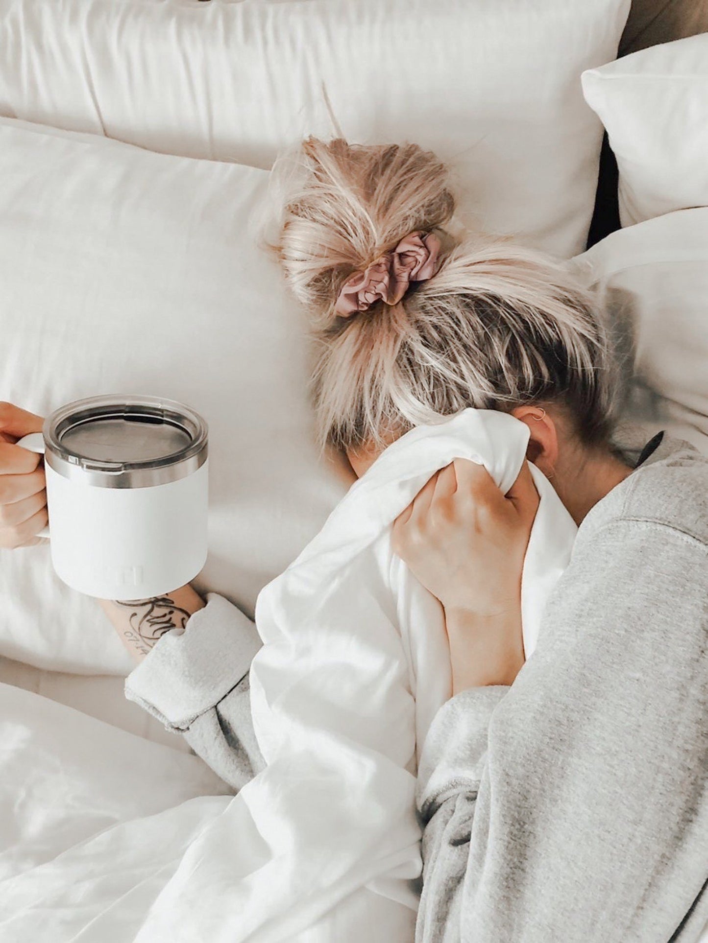 woman in bed with scrunchie in her hair